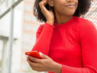 woman with red jumper on using phone